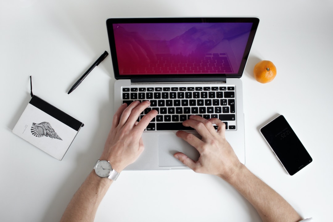 A man typing on his laptop